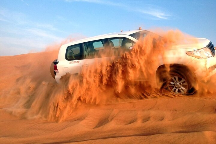 Experience the rush of dune bashing in a powerful 4x4 racing over golden sands as you explore the stunning landscapes of the Dubai desert. Adventure awaits!